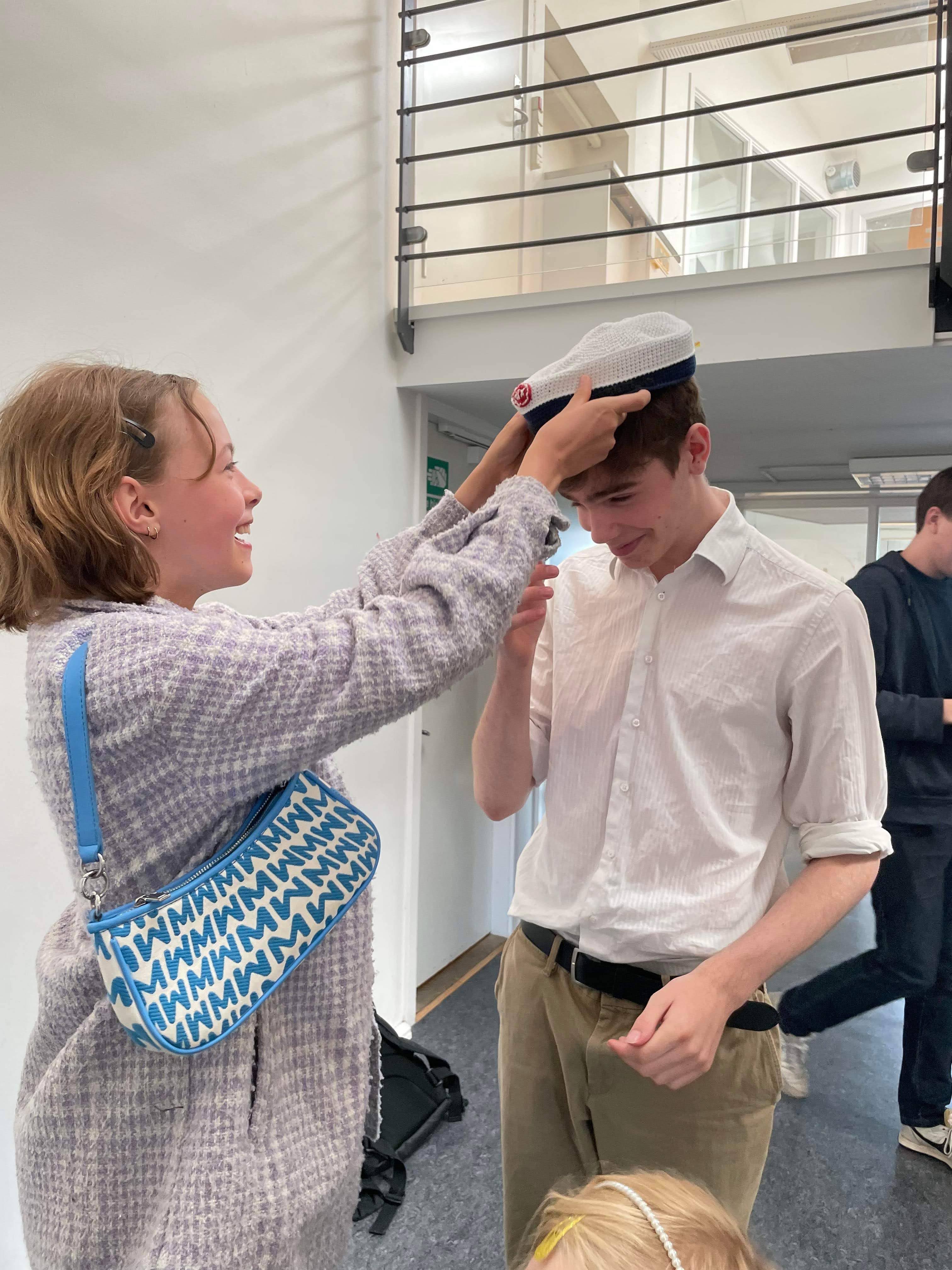 Markus receiving his student cap after completing the Higher Technical Examination Programme